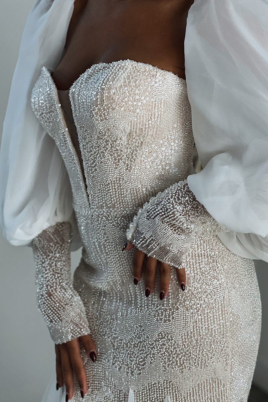 Detail shot of a beaded dress with dramatic balloon sleeves, captured by wedding content creator Ivoura.